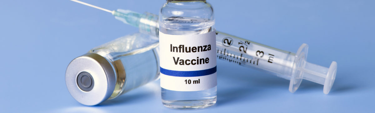 Influenza vaccine, syringe, and vials.