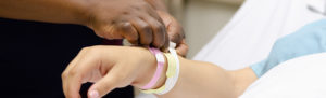 Nurse Placing armband on patient