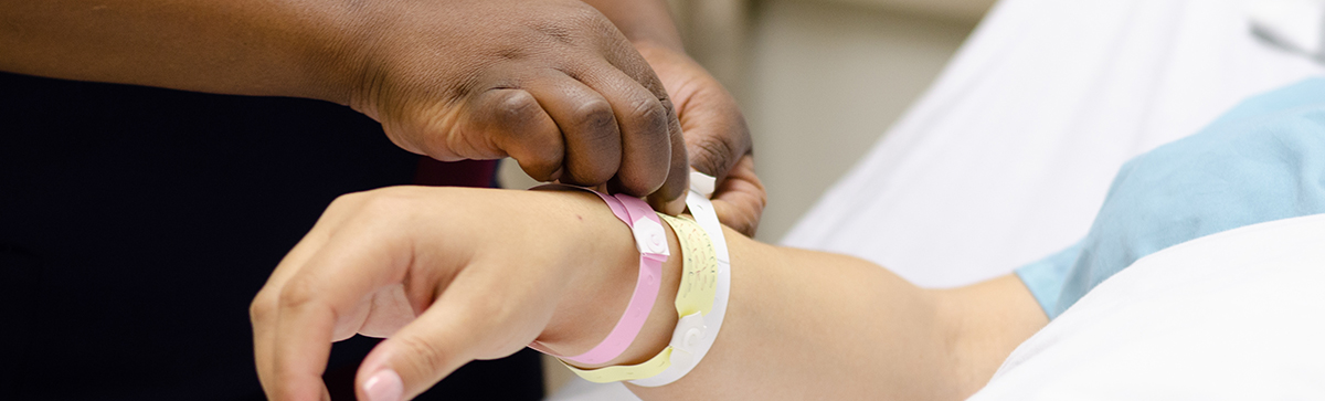 Nurse Placing armband on patient