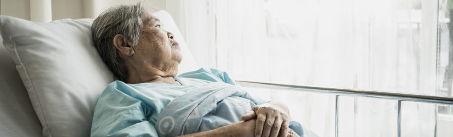 Elderly woman in hospital bed