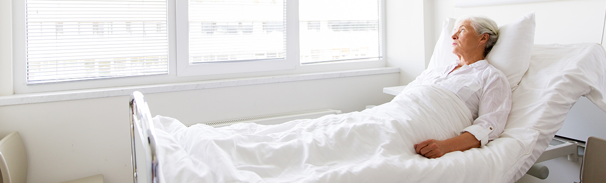 Elderly woman in hospital bed
