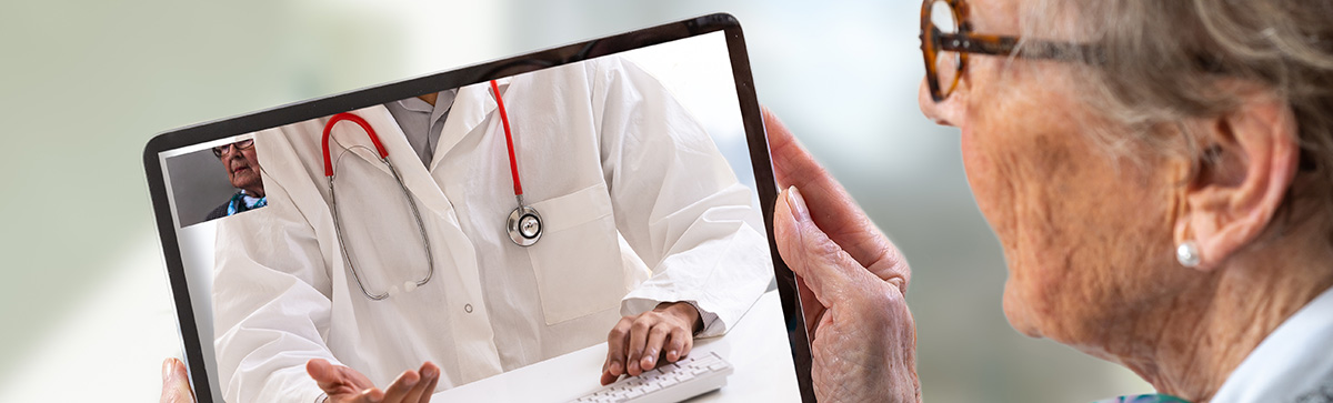 Senior woman consults a e-health doctor with tablet