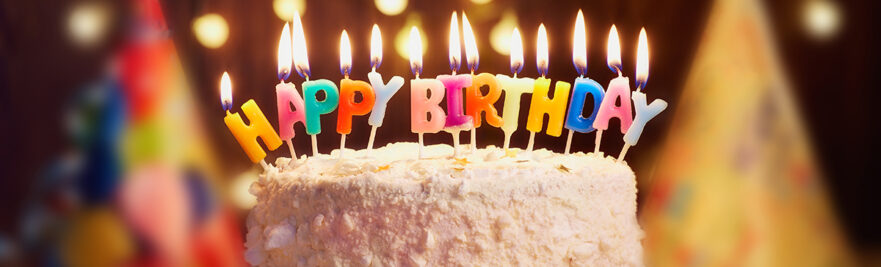 Birthday cake with candles spelling Happy Birthday