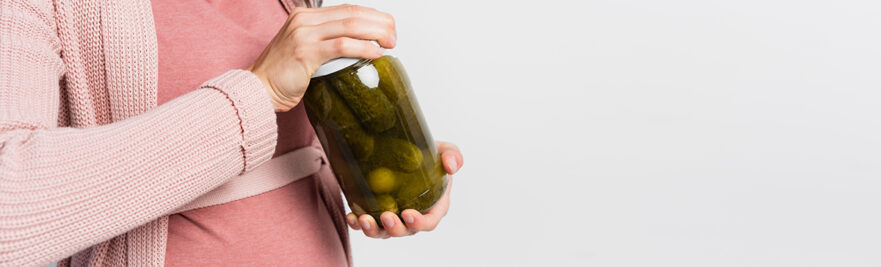 Woman opening a pickle jar