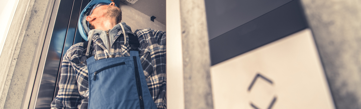 Man working on elevator maintenance.