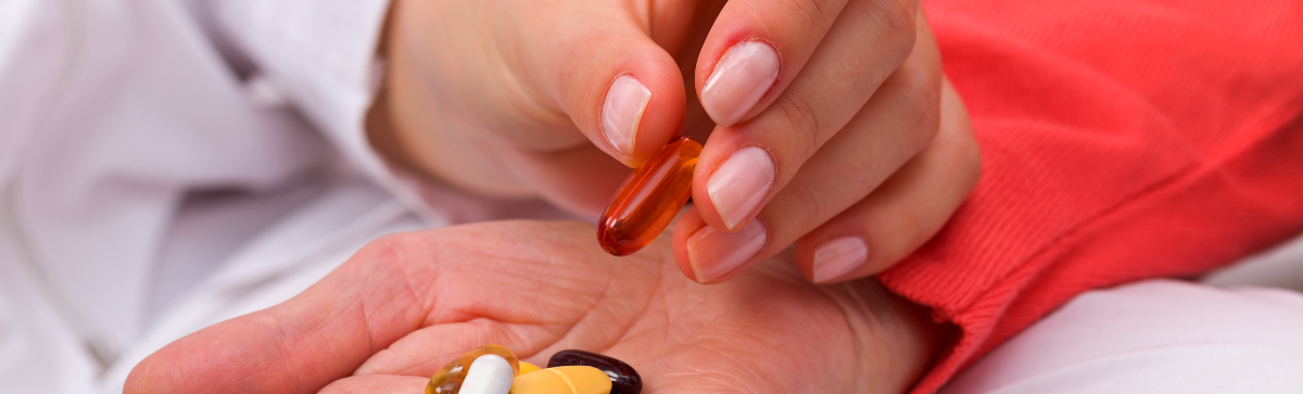 A caregiver providing an elderly person with medications
