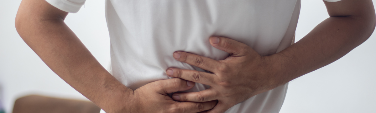 Person holding their stomach in pain.