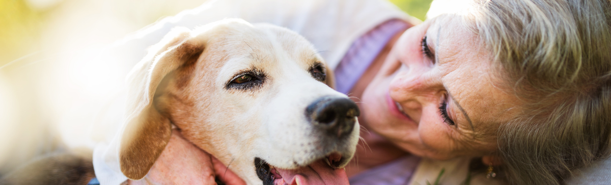 Elderly woman hugging dog