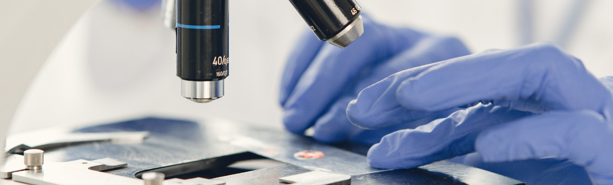 Scientist looking under the microscope.